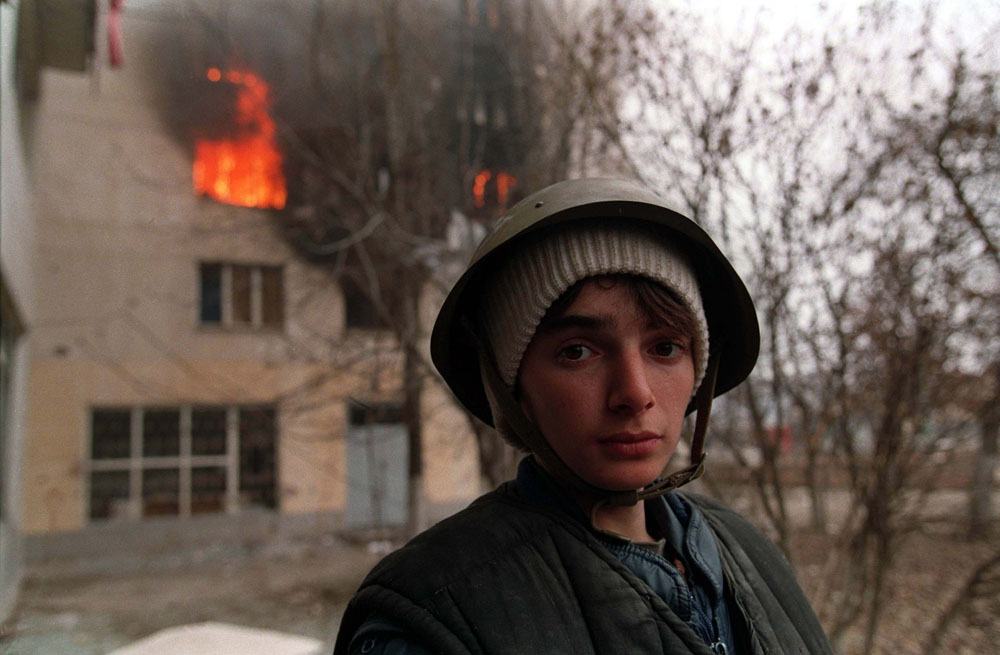 A Chechen stands in the street during the battle for Grozny.